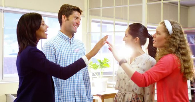 Group of happy business executives giving high five in office 4k