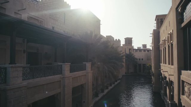 UAE, 2017: Madinat jumeirah. Architecture and attractions in the UAE. Historical center in Abu Dhabi. The sun's rays shine through the building of the tower.