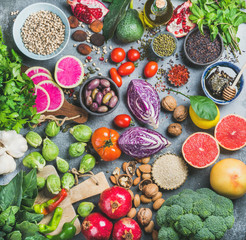 Clean eating concept over grey concrete background, top view. Vegetables, fruit, seeds, cereals,...