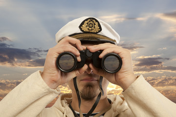 Captain looks through a binoculars