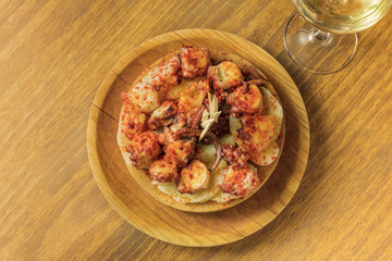 Photo of octopus with fried potatoes, typical Spanish dish