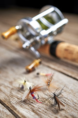 vintage handmade fishing lures with antique fishing rod and reel