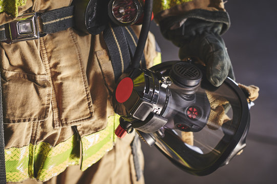 a firefighter holding an oxygen mask