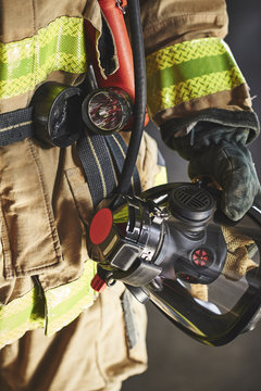 a firefighter holding an oxygen mask