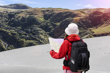 woman Hiker backpack looking the map guidance in lost of her way