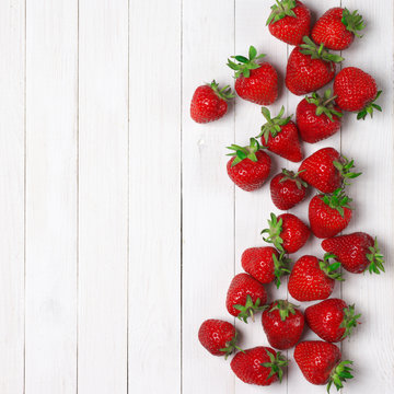 Strawberries on white wood