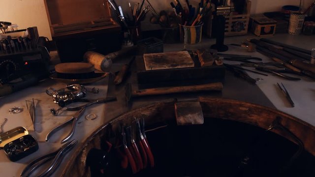 Goldsmith work tools on workbench in workshop 4k