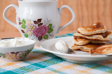 Delicious pancakes with sour cream for breakfast
