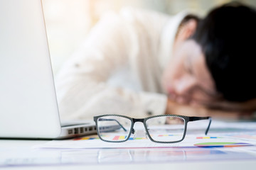  tired businessman sleeping while calculating expenses at desk i