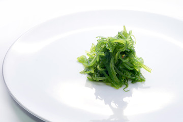 Hiyashi Wakame Chuka or seaweed salad in dish on white background , Japanese food