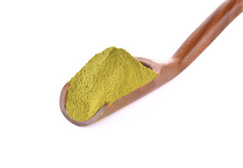 Green tea powder in a wooden spoon on a white background