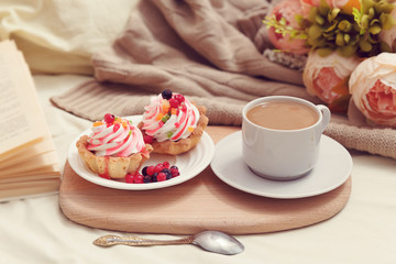 breakfast with coffe and tasty cakes in bed