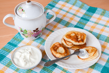 Delicious pancakes with sour cream for breakfast