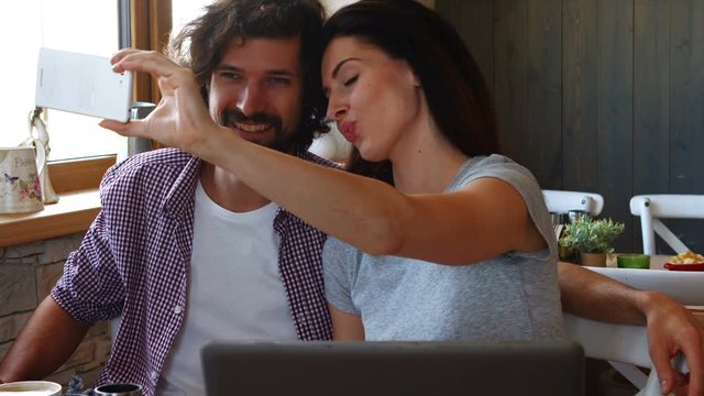 Couple taking selfie from mobile phone in bakery shop 4k
