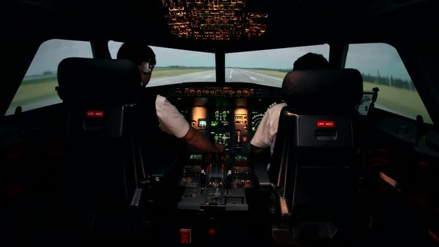 Takeoff of modern passenger aircraft at the international airport. Front view from the cockpit of Airbus A319 A320 A321 trough windshield. First officer and co-pilot at work during departure the