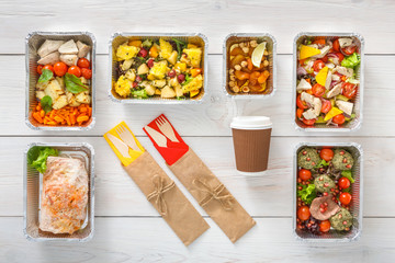 Healthy food take away in boxes, top view at wood