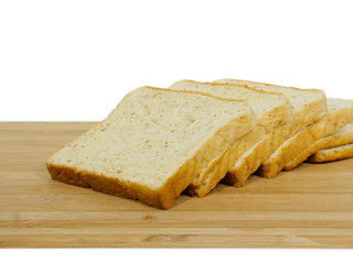 Side view of slices of toast bread on breadboard wooden, isolated on white background.