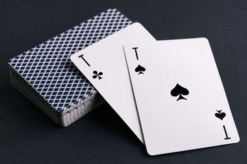 Close up of playing cards deck with two aces on dark background