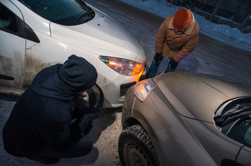 Two drivers after car collision on winter street
