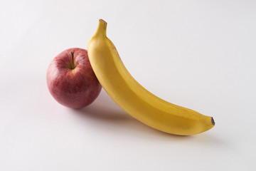 Fresh fruits: banana, apple on white background