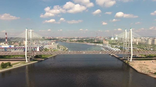 Side aerial view of cable stayed Bolshoy Obukhovsky bridge across Neva river. Flying toward to bridge. St. Petersburg, Russia
