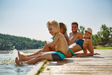 Familie plantscht mit Füßen im Wasser