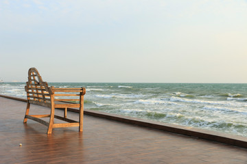 Chair in front of the see under the blue sky