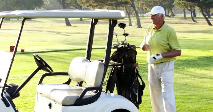 Male golfer putting golf club in golf bag at golf course 4k