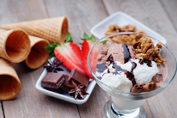 Ice cream sundae, waffle cone, walnuts and strawberry 