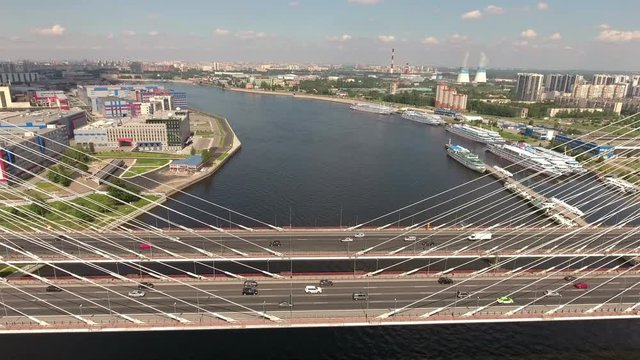 Aerial view at the cable-stayed Bolshoy Obukhovsky Bridge and Utkina Zavod district. Neva river. City ringroad (KAD) is on the bridge. Clip with timelapse part. St. Petersburg, Russia
