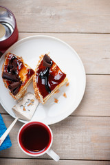 Pieces of cake, metal paddle and cup of tea 