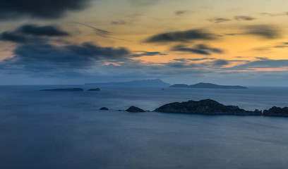 Long exposure Panoramic Seascape at dusk. View of the cliff into the sea and distant islands. Agios Stefanos cape. Afionas. Corfu. Greece.