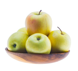 big ripe juicy yellow golden apples in wooden bowl isolated on white background