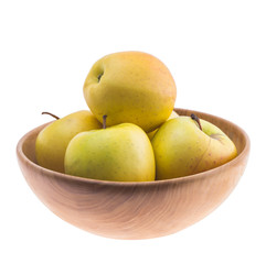 big ripe juicy yellow golden apples in wooden bowl isolated on white background