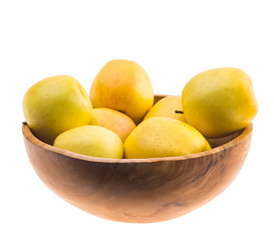 big ripe juicy yellow golden apples in wooden bowl isolated on white background
