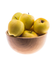 big ripe juicy yellow golden apples in wooden bowl isolated on white background