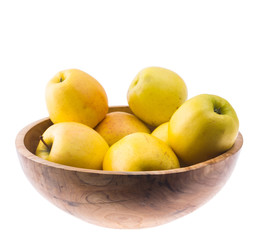 big ripe juicy yellow golden apples in wooden bowl isolated on white background