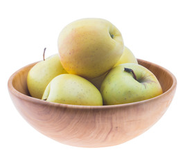 big ripe juicy yellow golden apples in wooden bowl isolated on white background