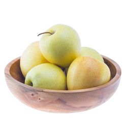 big ripe juicy yellow golden apples in wooden bowl isolated on white background