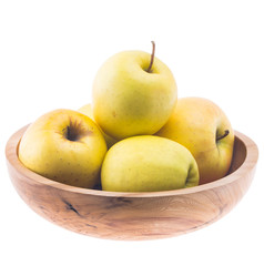 Naklejka na ściany i meble big ripe juicy yellow golden apples in wooden bowl isolated on white background