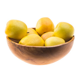 big ripe juicy yellow golden apples in wooden bowl isolated on white background