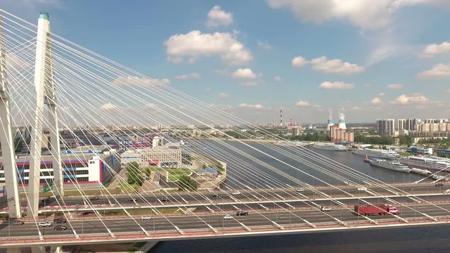 Main span and ramps of cable-stayed Bolshoy Obukhovsky Bridge. Cars driving on ring road. Aerial view. The bridge across Neva river. St. Petersburg, Russia
