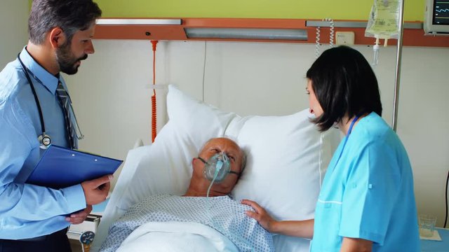 Doctor and nurse interacting with patient at hospital