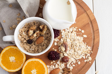 oranges, cereal and berries on a tray top view