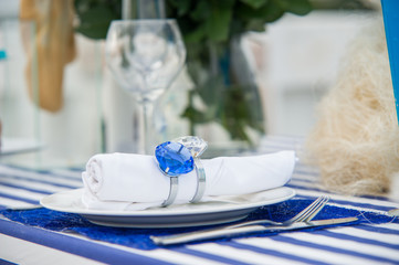 Coordinated decorative napkin on a plate with cutlery on  table in a cafe, serving table in a cafe, Empty outdoor restaurant table, Empty glasses in restaurant