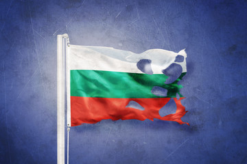 Torn flag of Bulgaria flying against grunge background