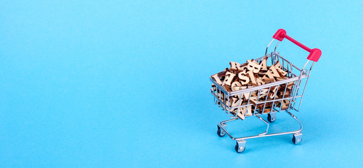 Shopping basket with letters of the alphabet made of wood on a blue background