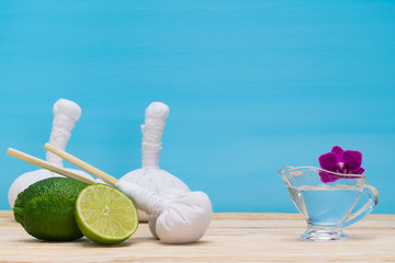 Set items for massage and beautiful flower on a blue background