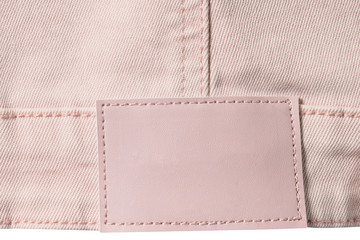 Pale pink denim with leather label with copy space