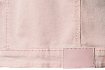 Pale pink denim with leather label for background